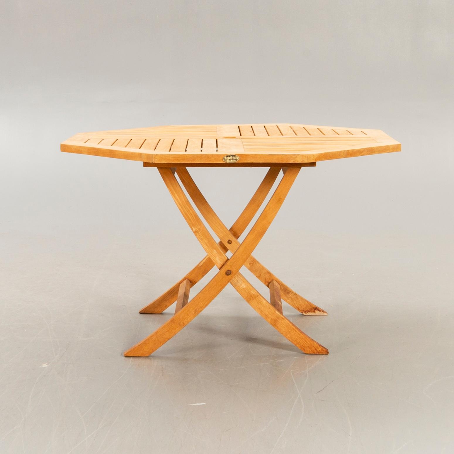A set of four chairs and a table Royal teak and others, later part of the 20th century.