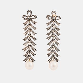 534. A pair of silver and 18K gold earrings with cultured pearls and set with eight-cut diamonds.