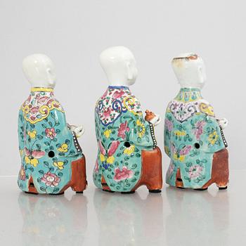 A group of three Chinese porcelain 'Laughing boys' figures, Qing dynasty and later.