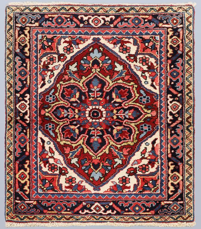 A semi-antique Heris rug, approx. 90 x 78 cm.