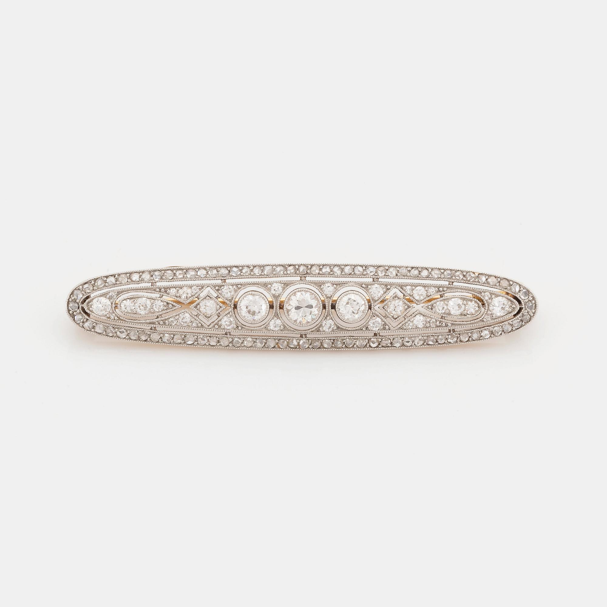 A platinum and 18K gold brooch set with old- and rose-cut diamonds.