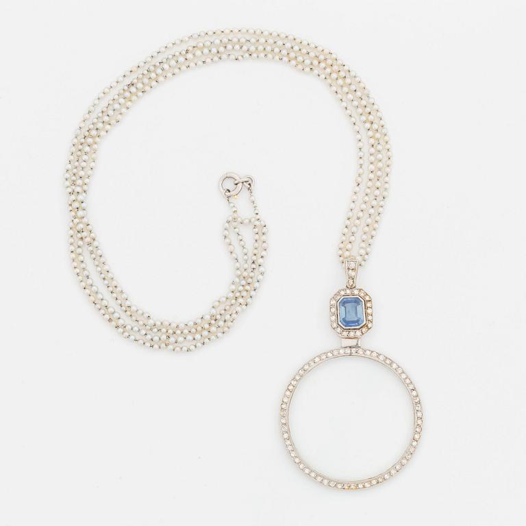 A platinum lorgnette set with a faceted sapphire and rose-cut diamonds.