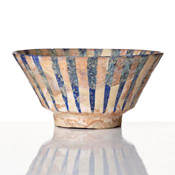 A cobalt glazed radila design pottery bowl, Persia (Iran), 12th/13th century.