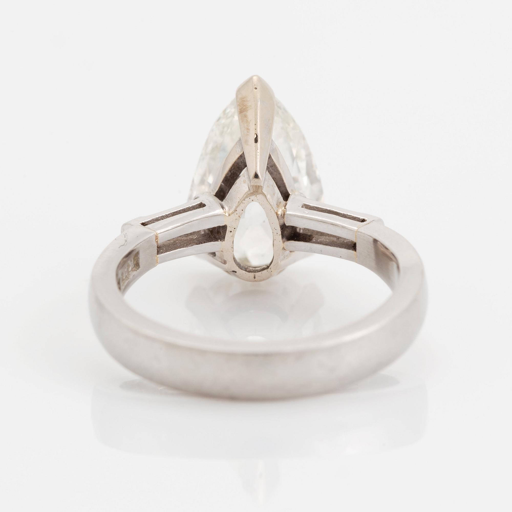 A platinum ring set with a pear shaped old-cut diamond weight ca 3.00 cts quality ca I si2.