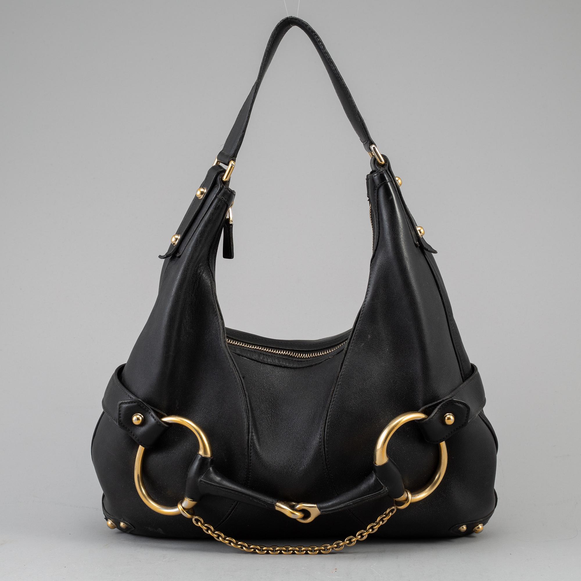 GUCCI, a leather horse-bit bag.