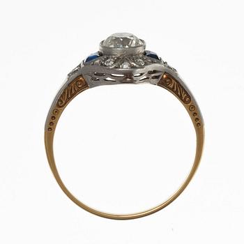 A RING, 18K gold, platinum. Old cut diamonds c. 0.75 ct  Center stone c. 0.65 ct vs, sapphires c. 0.40 ct .