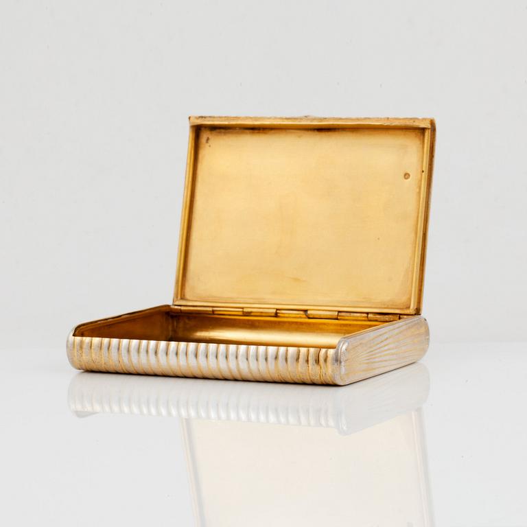 A Russian 20th century silver-gilt cigarette-case, marks of Anna Ringe, St. Petersburg 1908-1917.