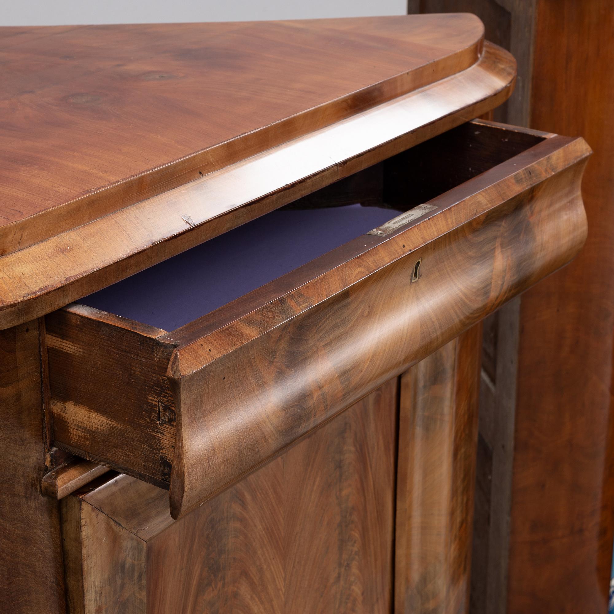 A pair of mahogany corner cabinets, mid 19th Century.