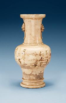 A cream glazed vase, Ming dynasty, with an inscription that dates it to 1608.