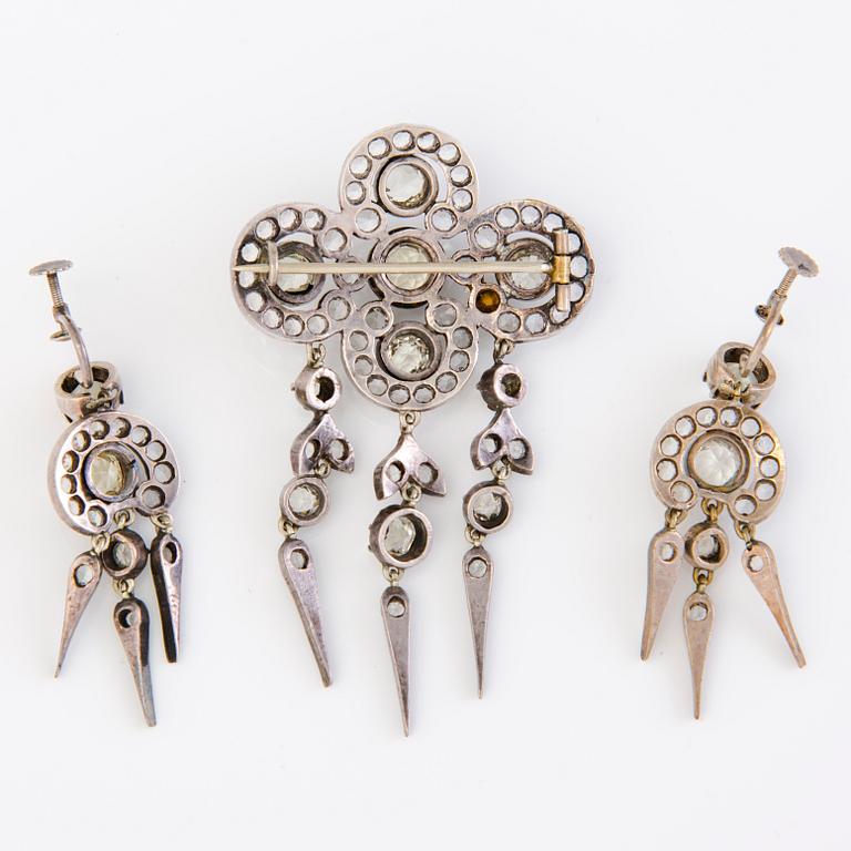 A set of silver earrings and a brooch with glass gems so called "Paste jewelry" Late 19th century.