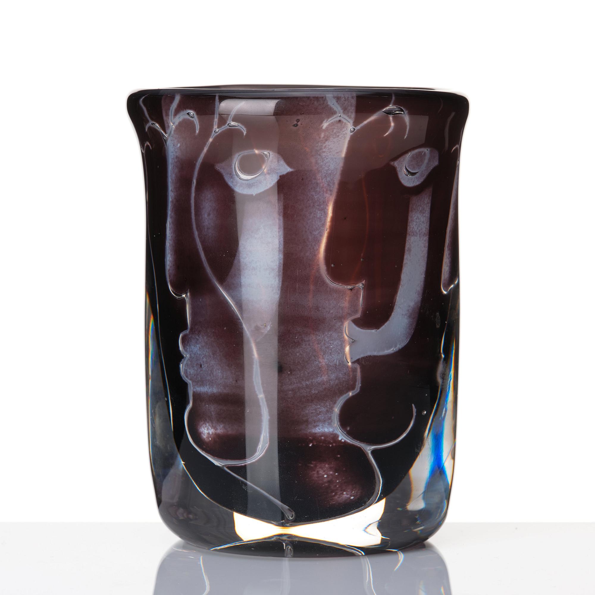 Ingeborg Lundin, an 'ariel' burgundy coloured glass vase decorated with faces, Orrefors Sweden 1972.