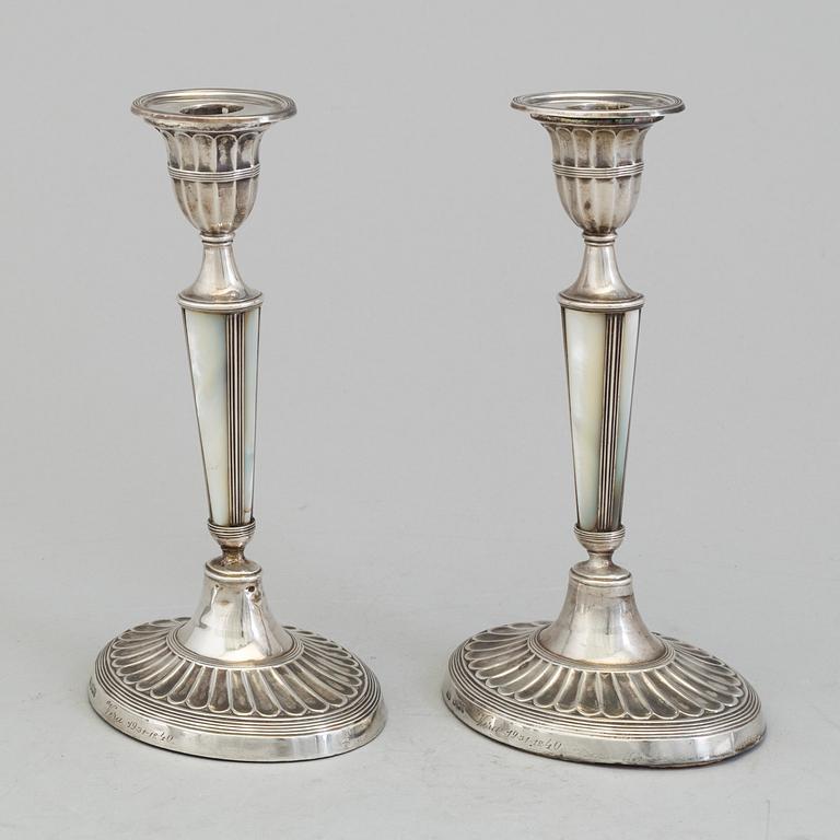 HARRISON BROTHERS & HOWSON, a pair of silver and mother of pearl candlesticks from Sheffield, England, 1926.