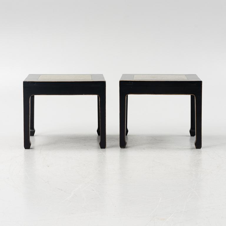A pair of blac painted side tables with stone tops.