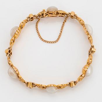 A 14K gold bracelet set with pearls, possibly natural, and old-cut diamonds.