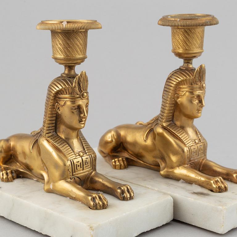 A pair of empire style 19th century candlesticks.