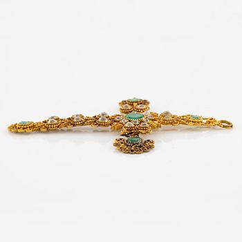 A cross in 14K gold set with faceted emeralds and old-cut diamonds, likely 18th century.