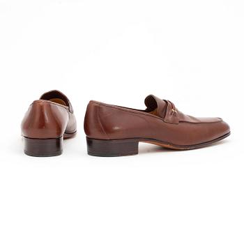 GUCCI, a pair of brown leather loafers.