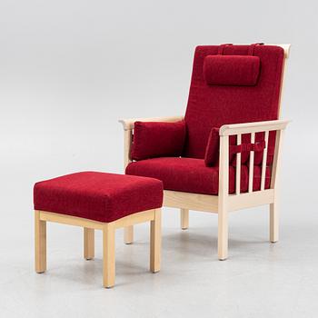A "Sundborn" easy chair with stool, from Albin I Hyssna.