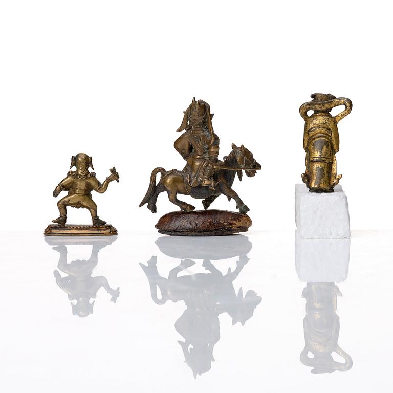 A group of three bronze miniatures sculptures of deities, China and Tibet, 18th Century.