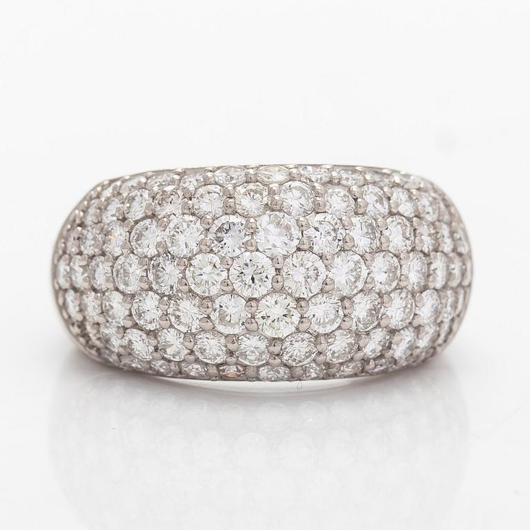 A platinum bombé ring with brilliant-cut diamonds.