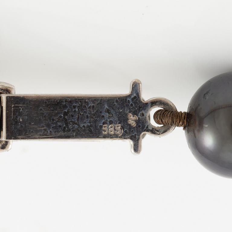 Necklace of cultured freshwater pearls, clasped with 14K white gold and round brilliant-cut diamonds.