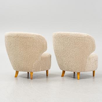 A pair of Scandinavian Modern 1940s cheepskin armchairs.