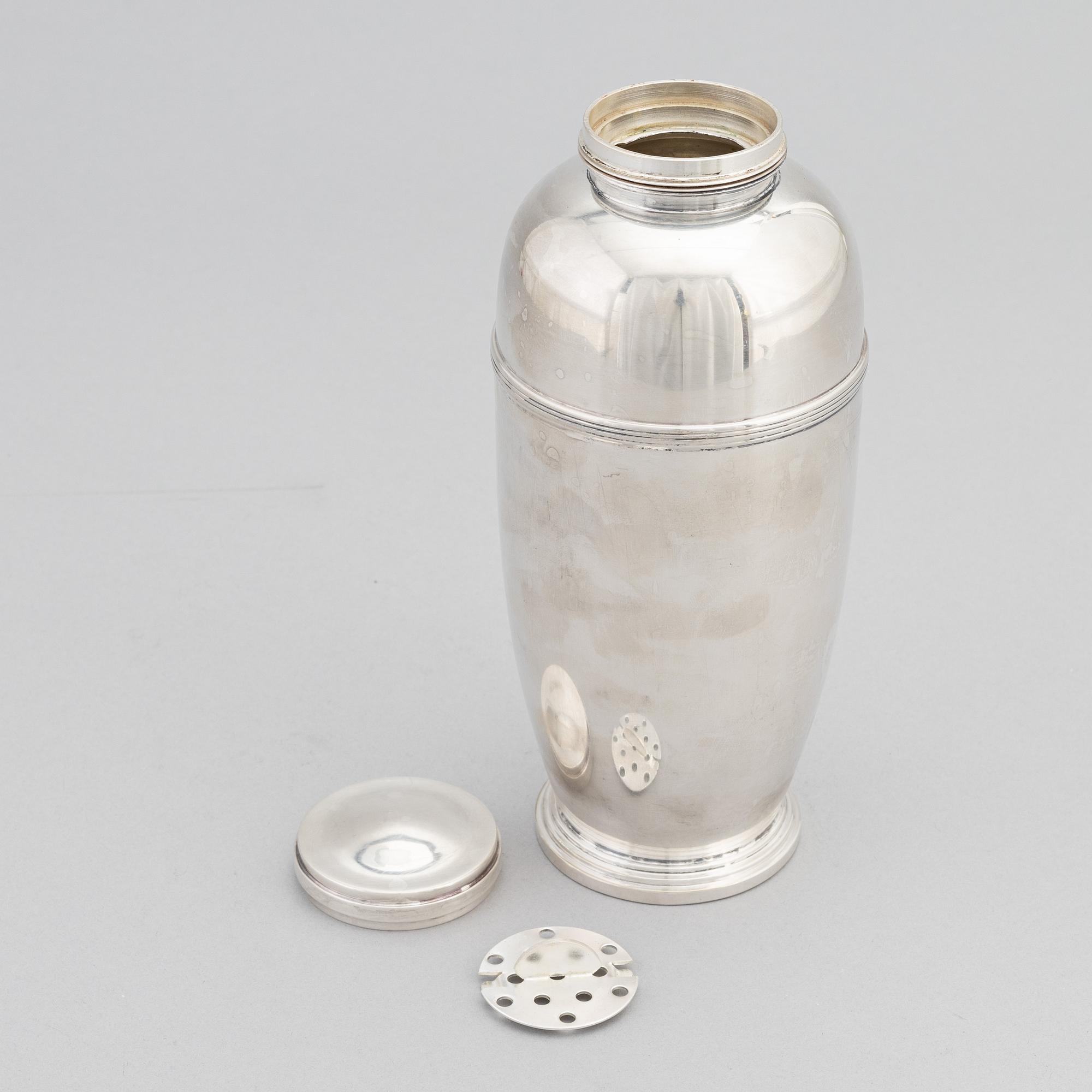 A silver plated shaker, C.G. Hallberg and a set of twelwe cocktail glasses, GAB, second half of the 20th Century.