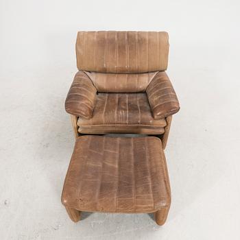 A leather armchair and fotstool by De Sede, Schweiz second half of the 20th century.