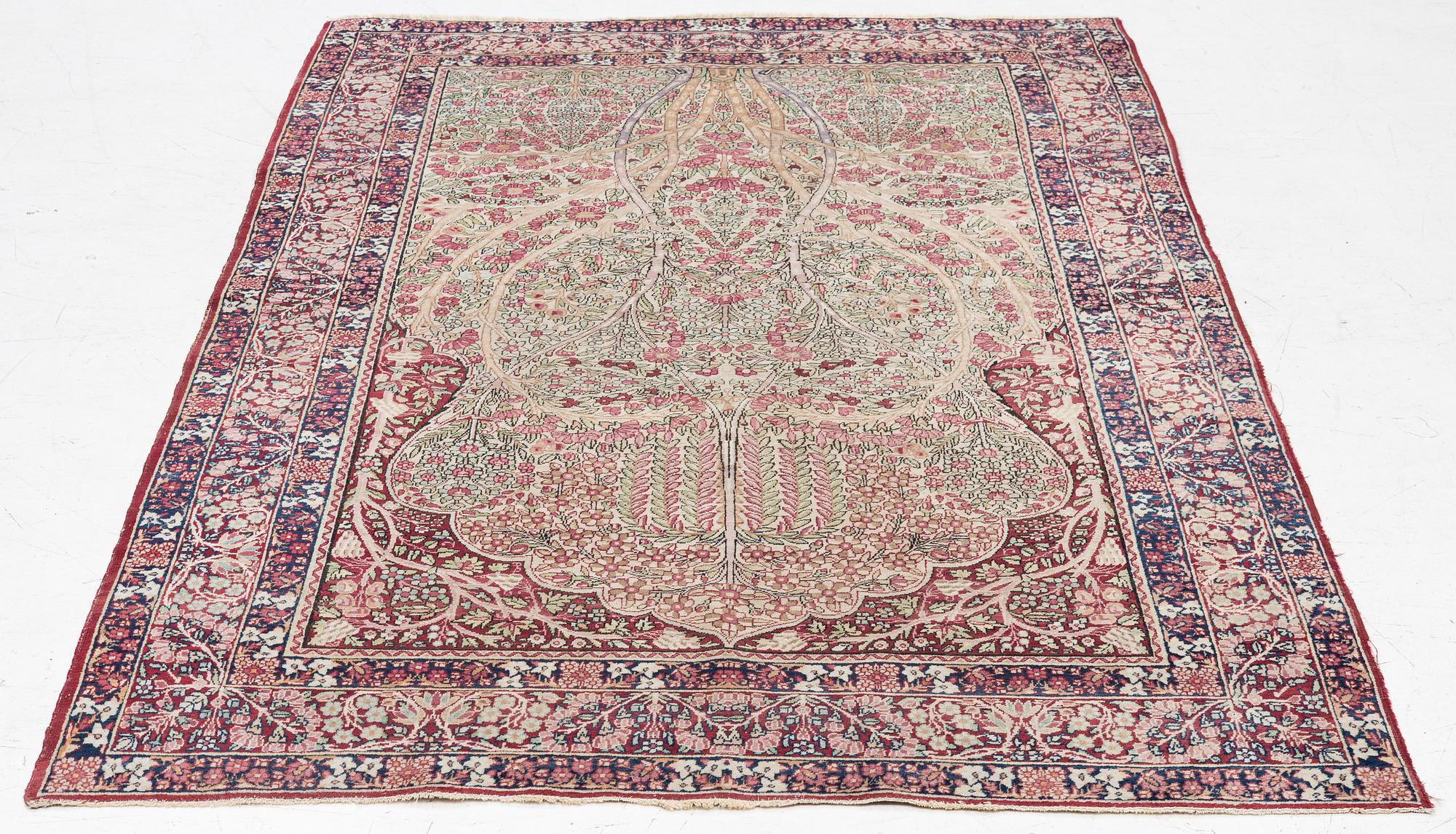 An antique Kirman rug, south Persia, c. 220 x 140 cm.