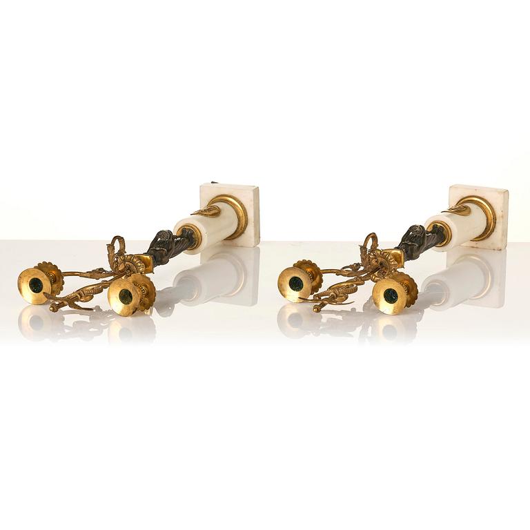 A pair of late Gustavian white marble and bronze candelabra.