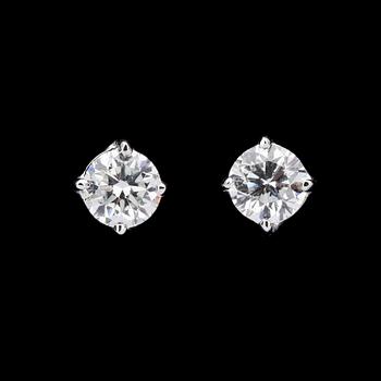 1072. A pair of brilliant cut diamond ear studs, each 0.70 cts.