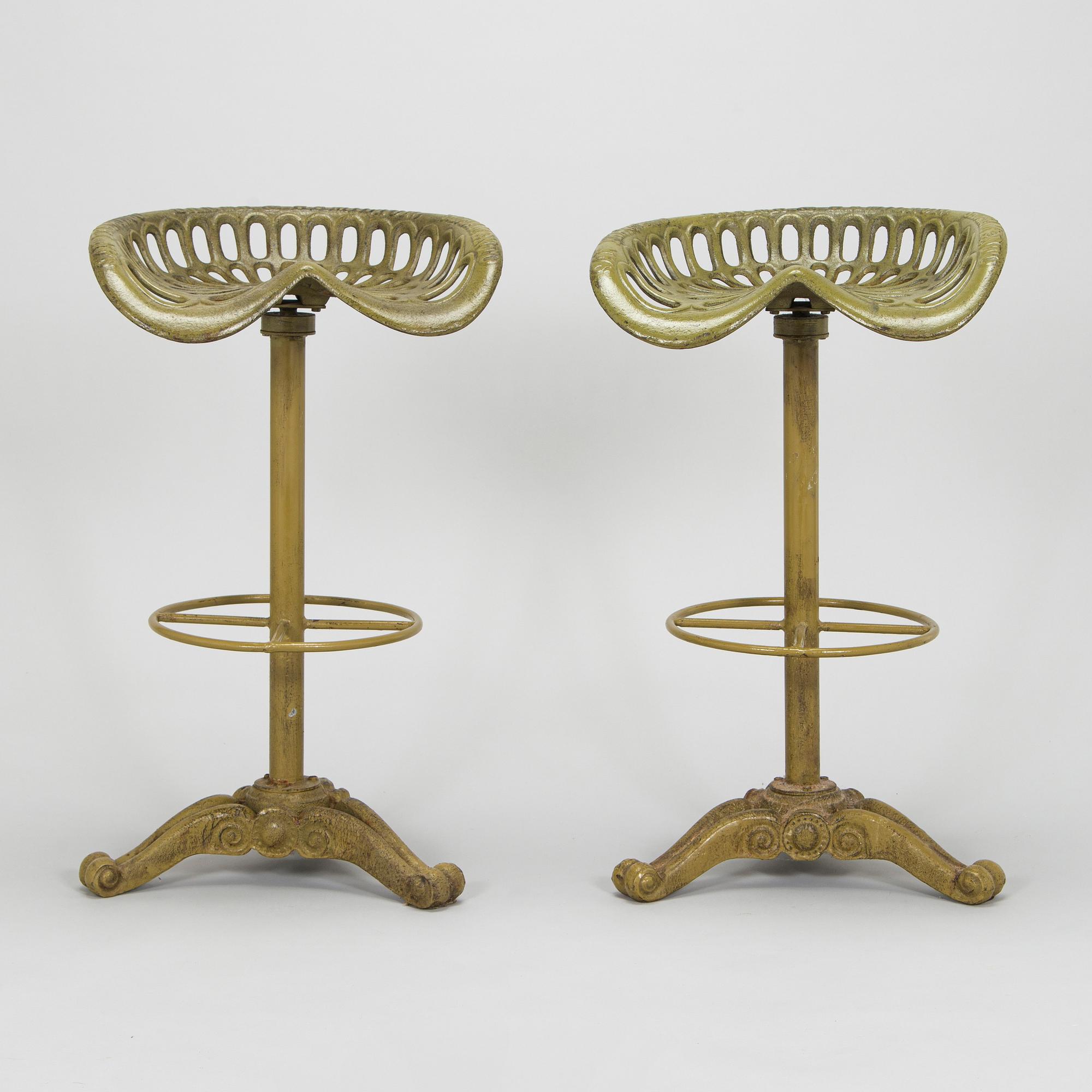 Four bar stools, painted cast iron, partly from the early 20th century.