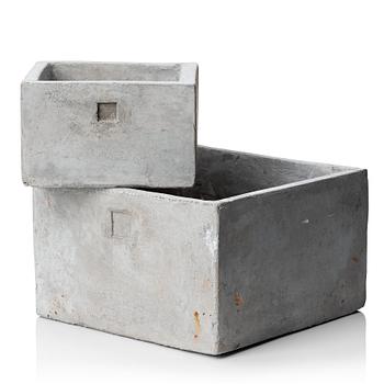 A pair of contemporary concrete flower pots.