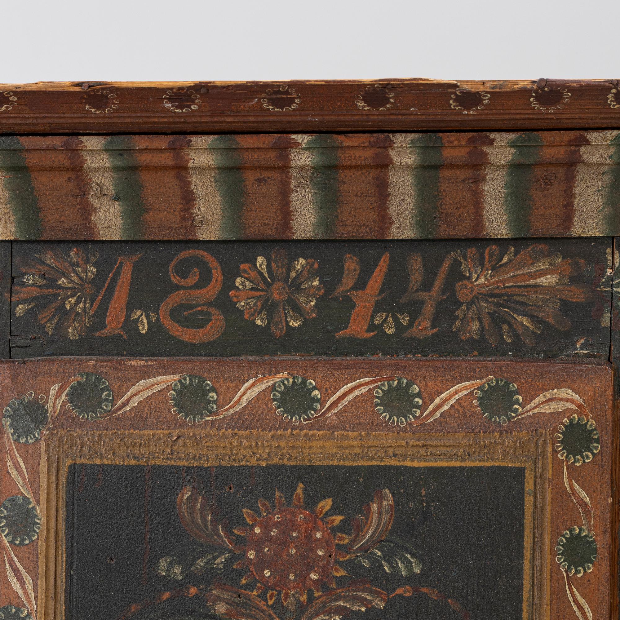 A corner hanging cabinet, dated 1844.