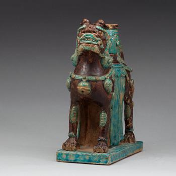 A turkoise and aubergine glazed figure of a Mythical beast, late Ming dynasty (1368-1644).