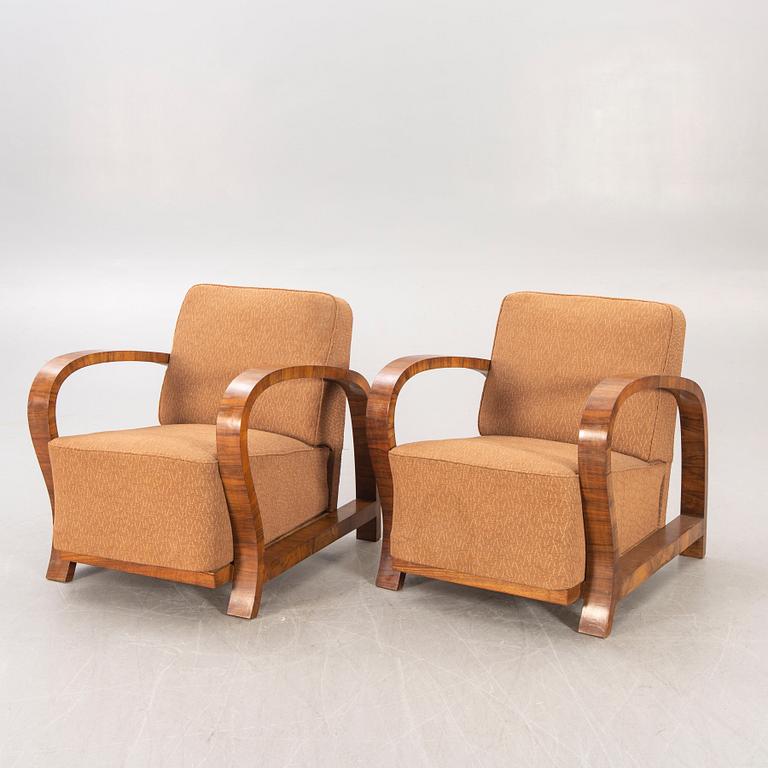 A pair of Art Deco walnut armchairs.