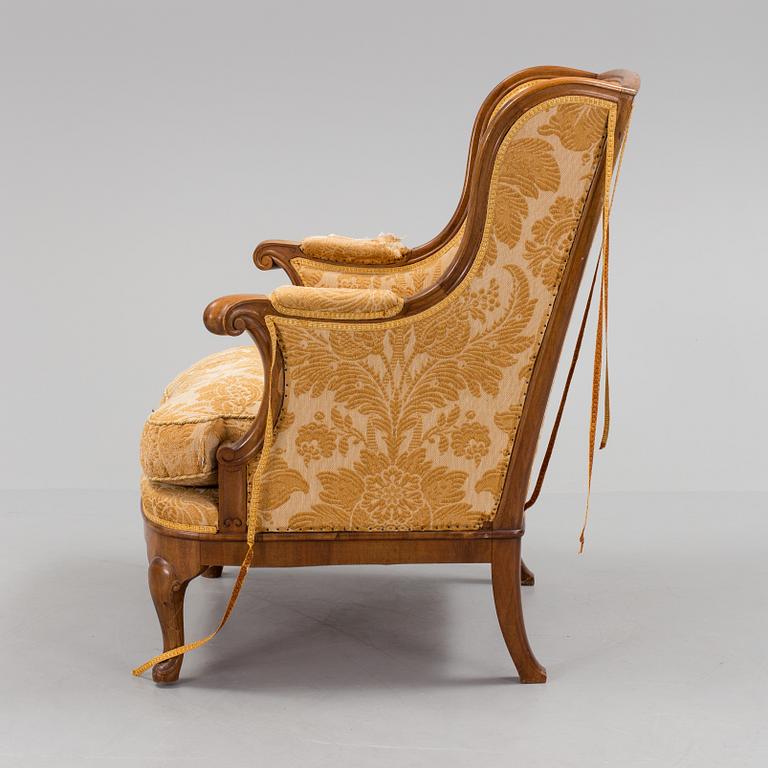 A Rococo style wing chair, first half of teh 20th Century.