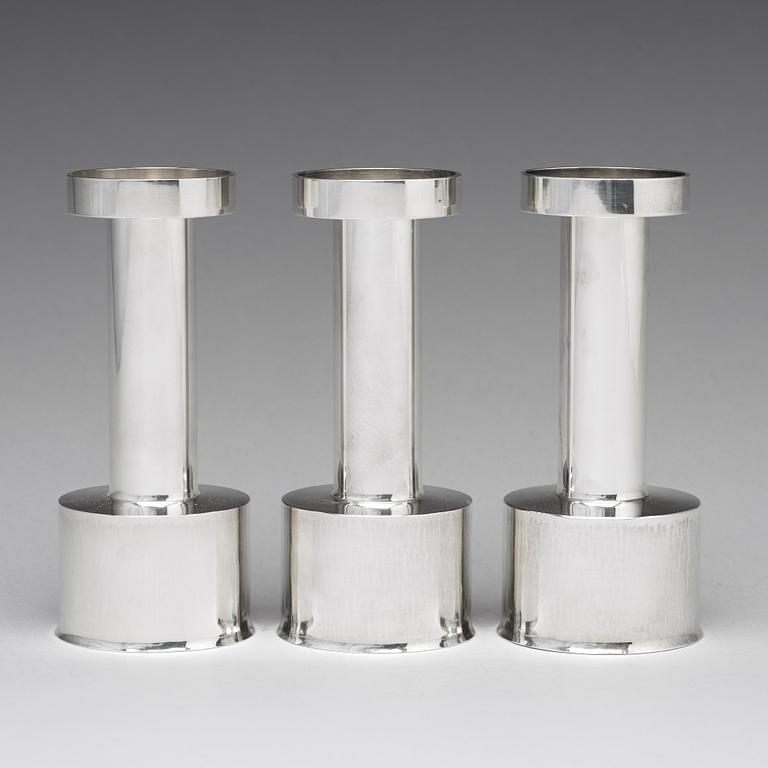 Sigurd Persson, a set of three sterling silver candlesticks, Stockholm 1965 and 1970, executed by Johann Wist.