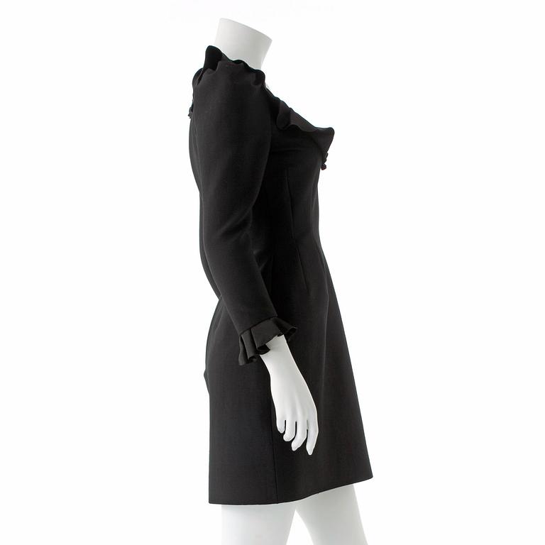 LANVIN, a black wool blend dress with ruffles.