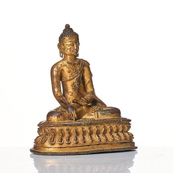 A gilt copper alloy figure of Buddha, Tibet/Nepal 15th Century.