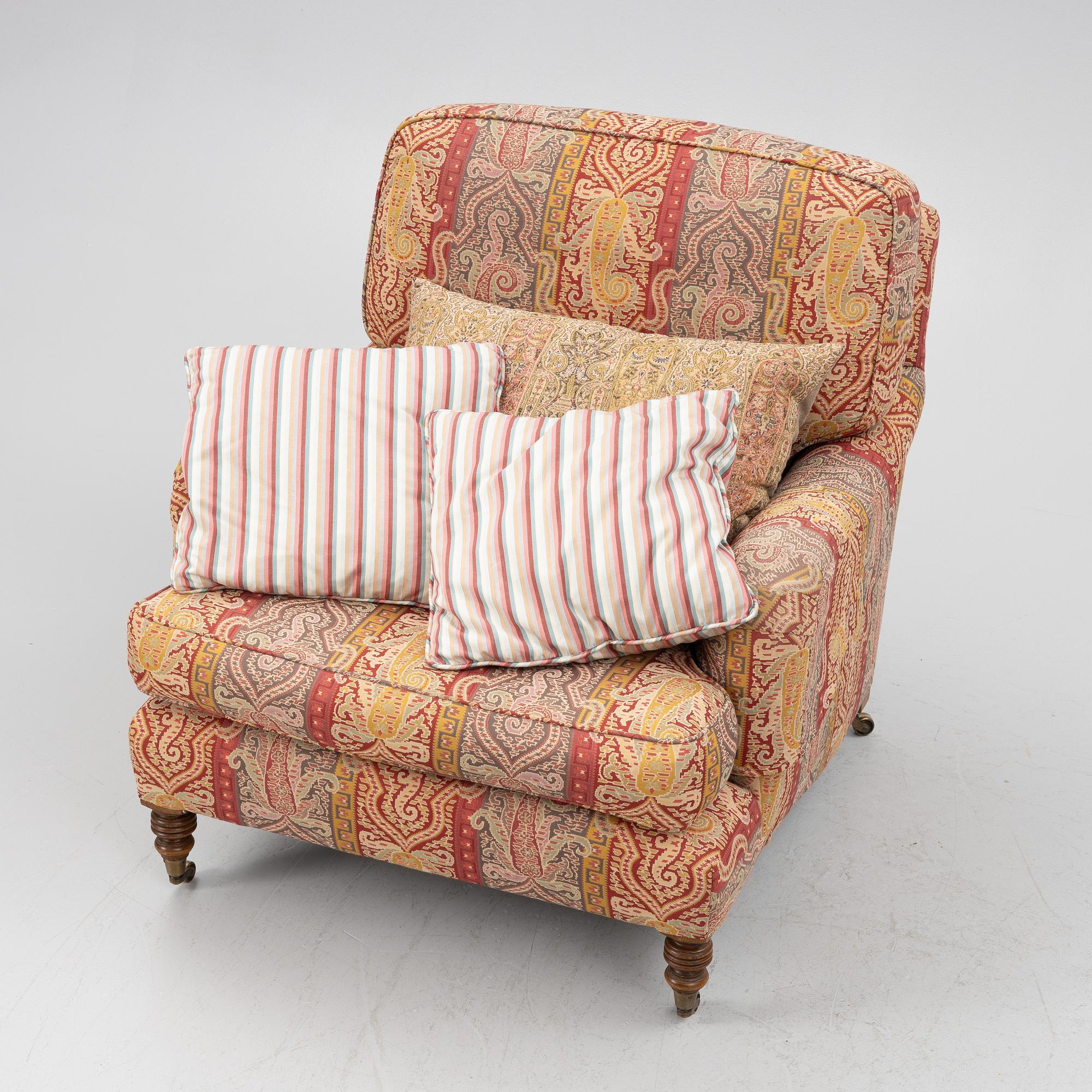 A Howard armchair with ottoman.