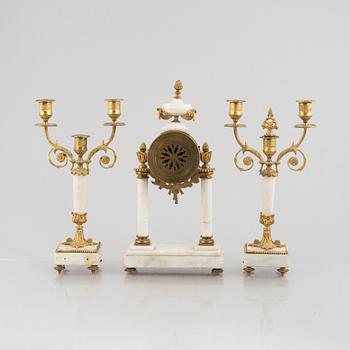 A Louis XVI-style mantel clock Paris, France and a pair of candelabras, late 19th century.