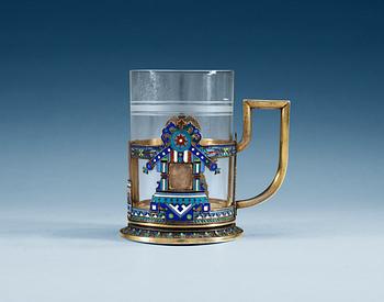 1195. A RUSSIAN SILVER-GILT AND ENAMEL TEA-GLASS HOLDER, Makers mark of Soltykov, Moscow 1885.