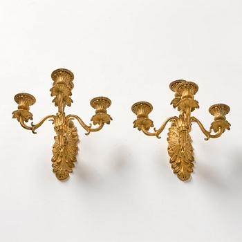 A pair of late Empire ormolu four-branch wall lights, circa 1840.