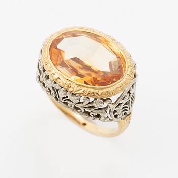 Gold ring with synthetic yellow sapphire.