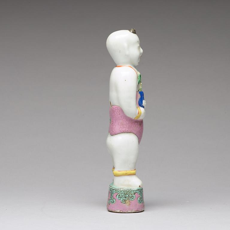 A famille rose porcelain figure of a laughing boy, Qing dynasty, 18th Century.