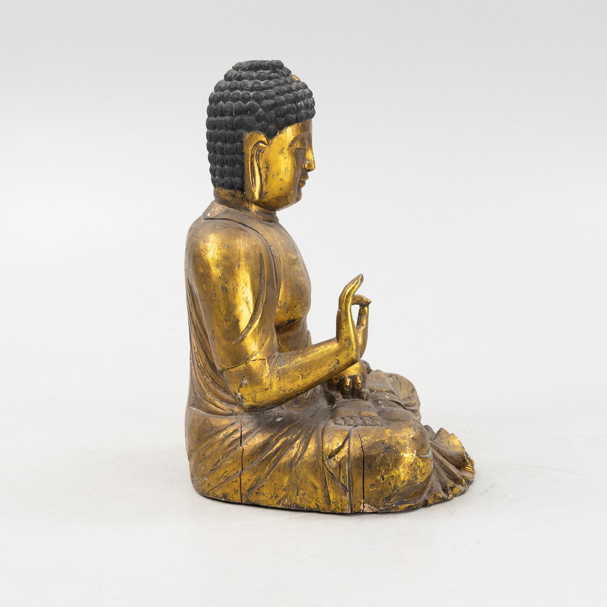 A massive gilded wooden figure of buddha, 20th century.