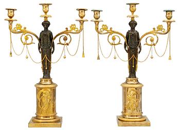 605A. A pair of late Gustavian early 19th century gilt and patinated bronze three-light candelabra.