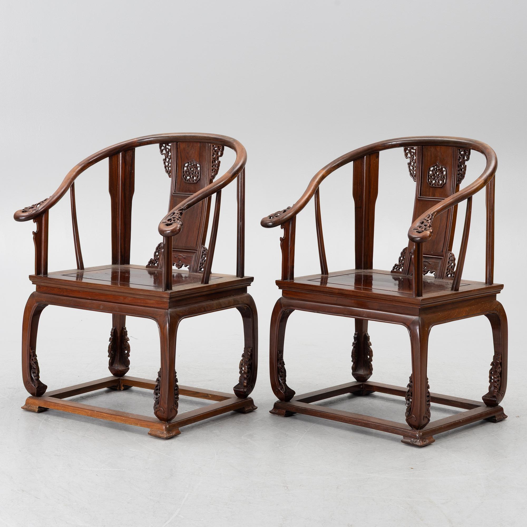 A pair of Chinese horseshoe-back hardwood armchairs, 1900s.