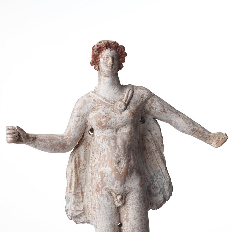 A Greek terrcotta sculpture of a young man, Hellenistic,  probably circa 3rd Century BC.